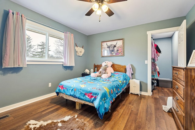 bedroom featuring ceiling fan and dark wood-type flooring