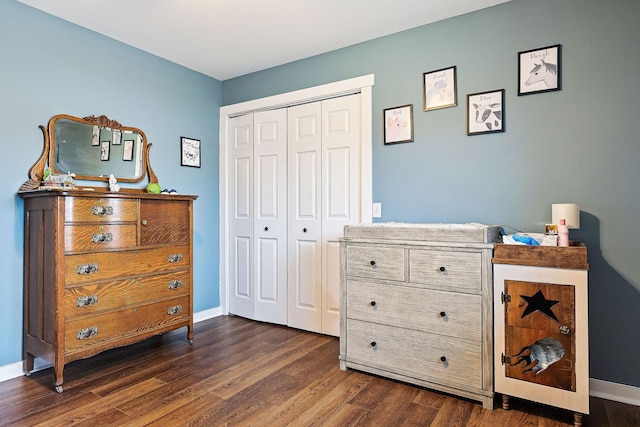 bedroom with dark wood-type flooring and a closet