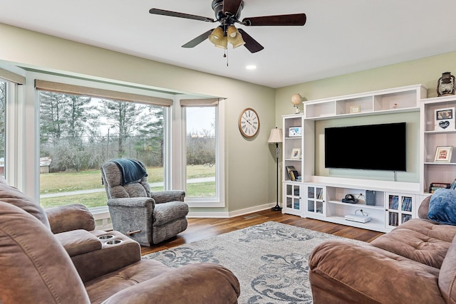 living room featuring hardwood / wood-style flooring and ceiling fan