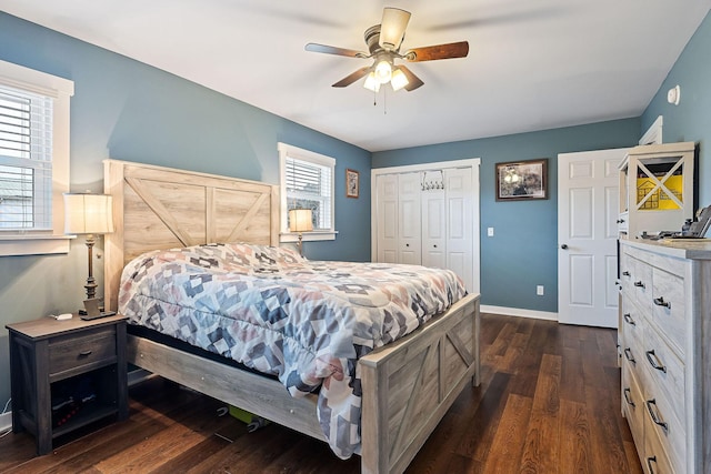 bedroom with a closet, dark wood-type flooring, and ceiling fan