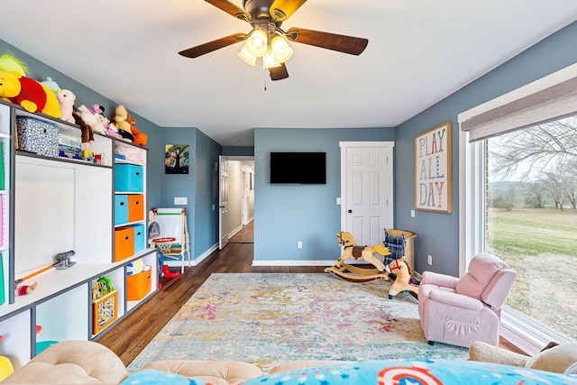 game room featuring ceiling fan and dark wood-type flooring