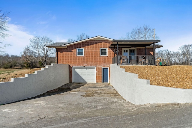 view of front of home with a porch and a garage