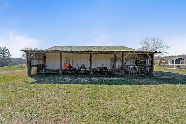 view of outdoor structure featuring a lawn