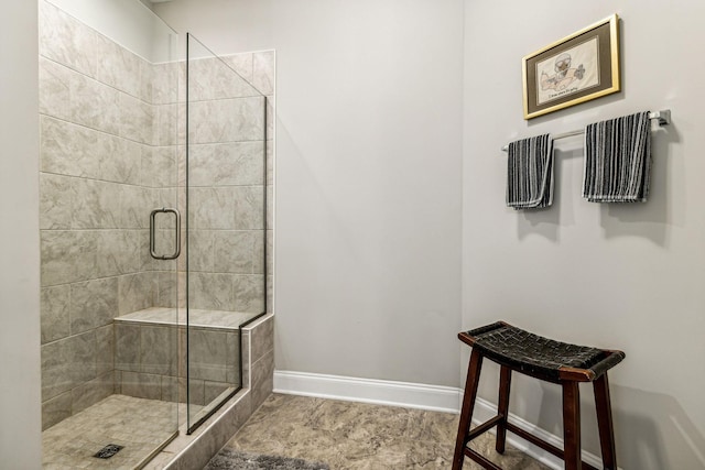 bathroom with a shower with door