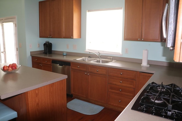 kitchen with stainless steel dishwasher, black gas stovetop, and sink