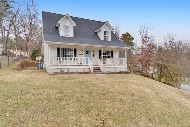 cape cod house featuring a porch and a front yard