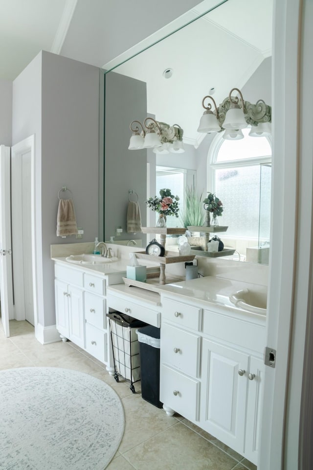 bathroom with tile patterned floors, vanity, crown molding, and vaulted ceiling