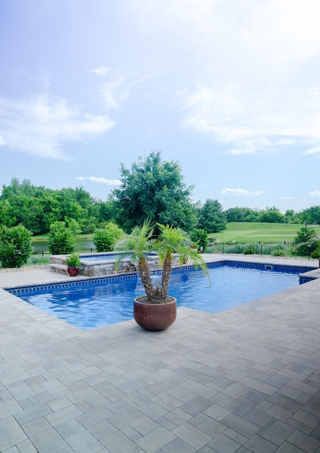 view of swimming pool with a patio area and an in ground hot tub