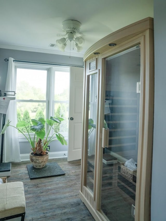 entryway featuring wood-type flooring, ceiling fan, and ornamental molding