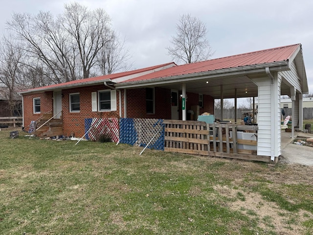 back of house with a yard and a carport