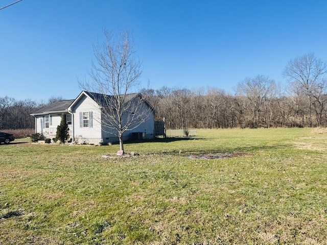 view of side of home featuring a lawn