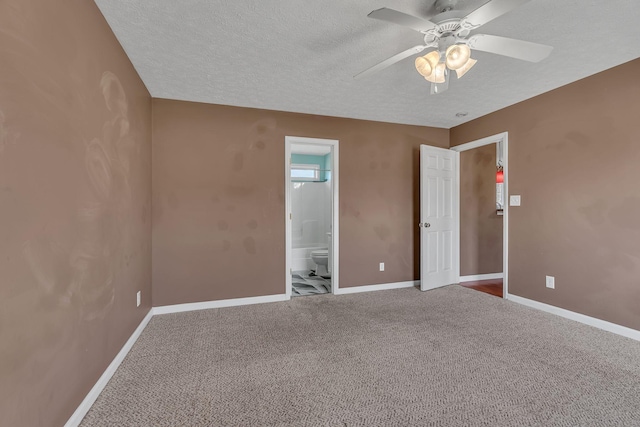 empty room featuring a ceiling fan, baseboards, a textured ceiling, and carpet flooring