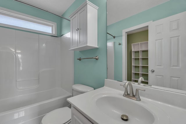 bathroom featuring vanity, toilet, and shower / washtub combination