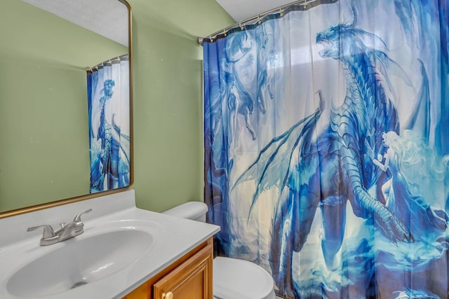 bathroom featuring a shower with shower curtain, toilet, and vanity