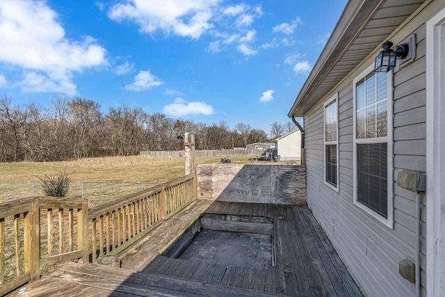 deck with a lawn and fence