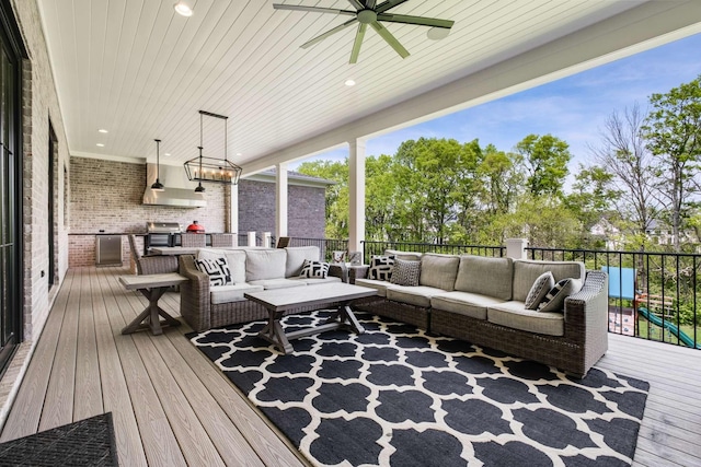 wooden terrace with an outdoor living space and ceiling fan