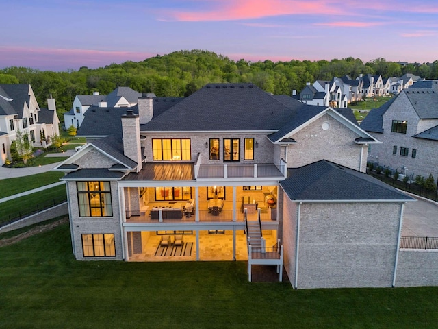 back house at dusk with a yard