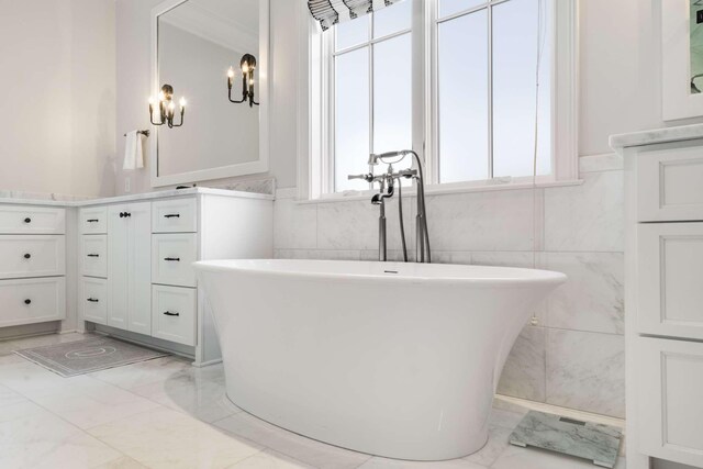 bathroom with vanity, a bathtub, and tile walls