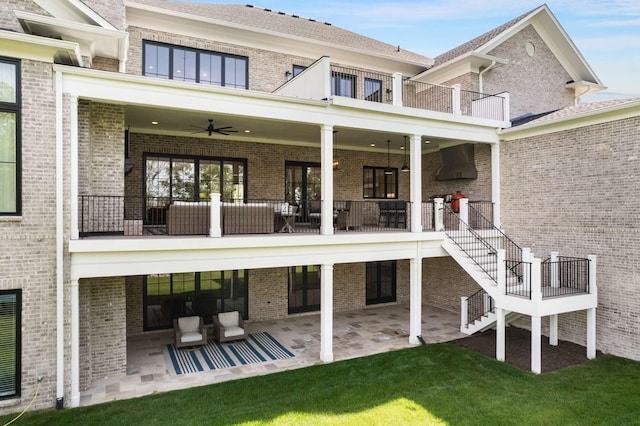 back of house featuring a patio area, ceiling fan, a balcony, and an outdoor living space