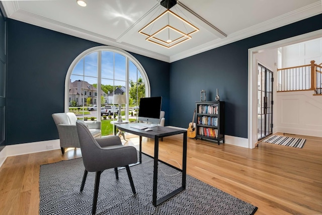 home office with an inviting chandelier, ornamental molding, and hardwood / wood-style flooring