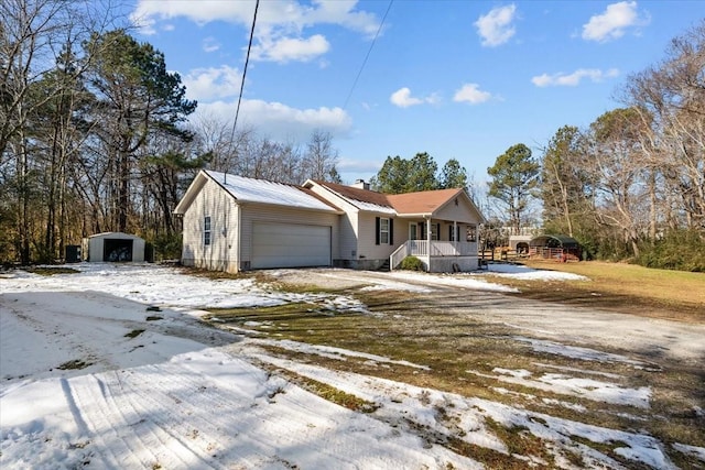 view of front facade featuring a garage, a porch, and a shed