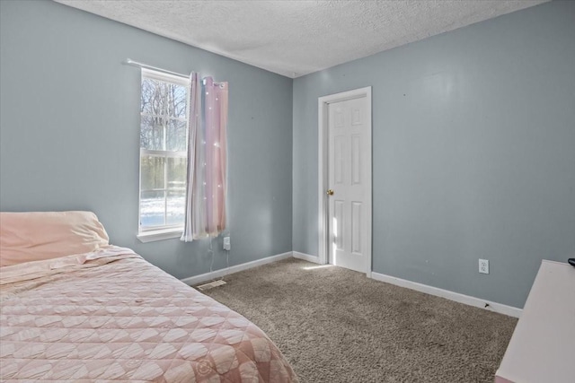 bedroom featuring a textured ceiling and carpet floors