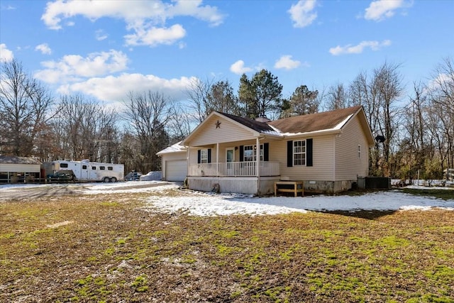 view of front of home with covered porch and a garage