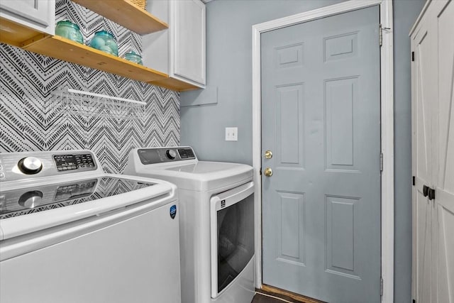 washroom featuring cabinets and independent washer and dryer