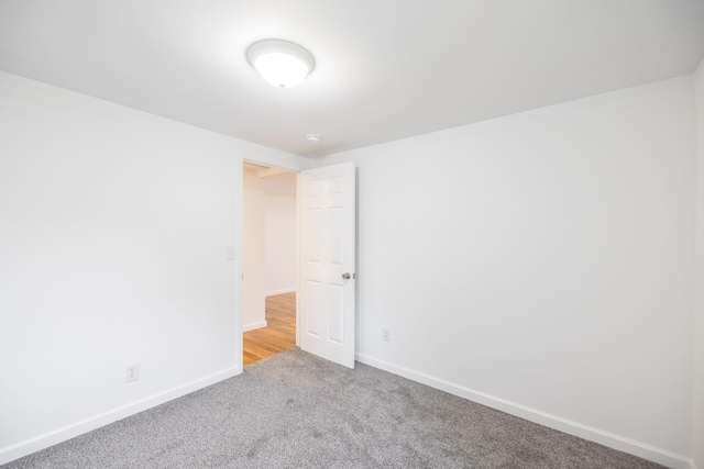 unfurnished room featuring light carpet