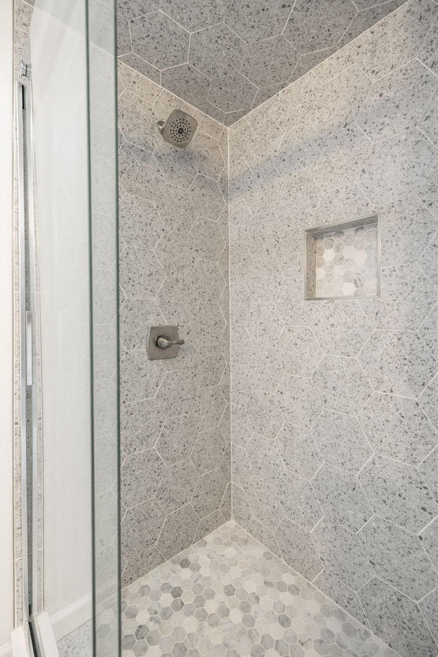 bathroom with a tile shower