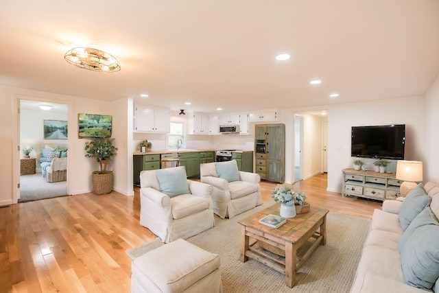 living room featuring light hardwood / wood-style floors and sink