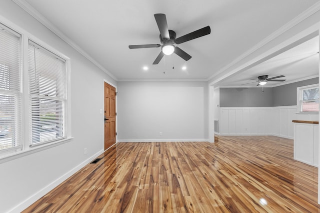 unfurnished living room with light hardwood / wood-style flooring, ceiling fan, and ornamental molding