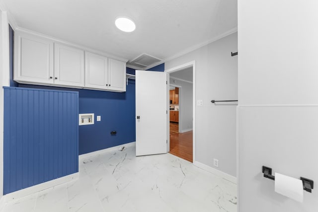 washroom with washer hookup, cabinets, and ornamental molding