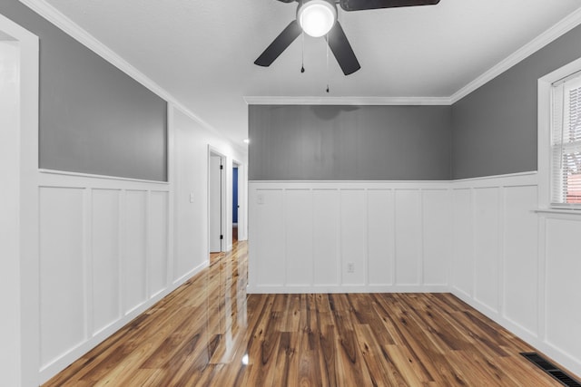 spare room with ceiling fan, hardwood / wood-style floors, and ornamental molding