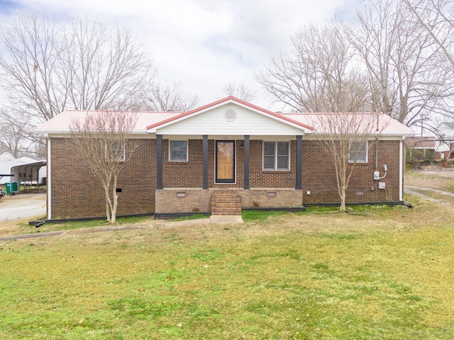 view of front of house featuring covered porch, a front yard, and a carport