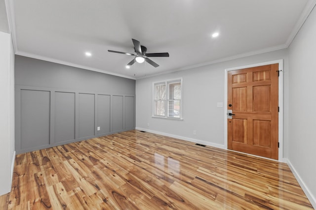 interior space featuring light hardwood / wood-style floors, ceiling fan, and crown molding