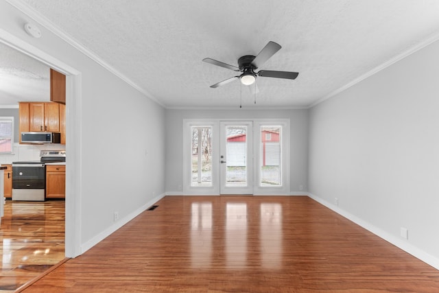 empty room with light hardwood / wood-style flooring, ceiling fan, and crown molding