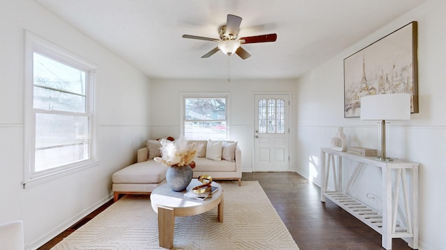 sitting room with ceiling fan and dark hardwood / wood-style floors