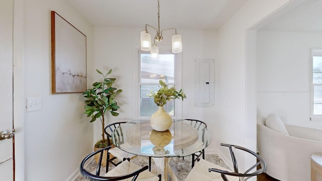 dining room featuring electric panel and a chandelier