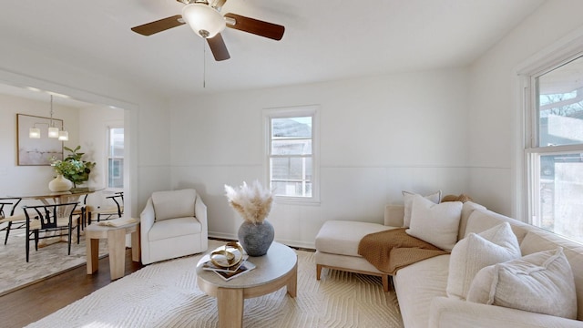 living room with ceiling fan and dark hardwood / wood-style flooring