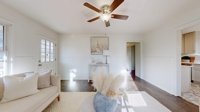 living room with dark hardwood / wood-style floors and ceiling fan