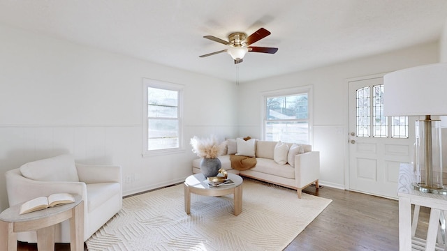 living room with hardwood / wood-style floors and ceiling fan