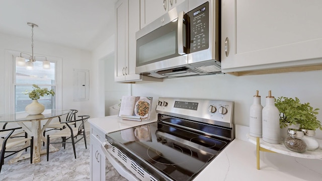 kitchen with white cabinets, a notable chandelier, and stainless steel appliances