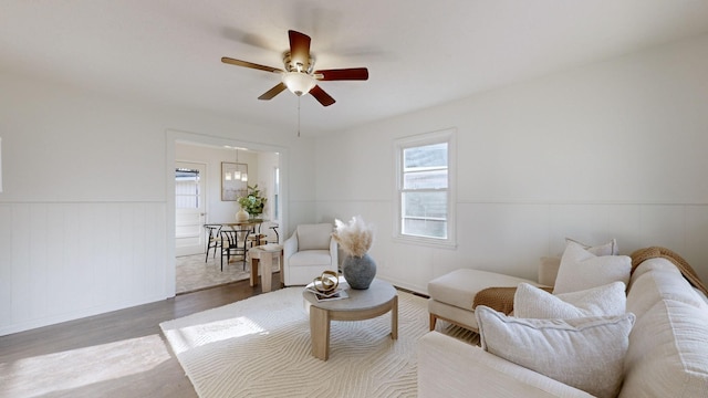 living room with ceiling fan and hardwood / wood-style flooring