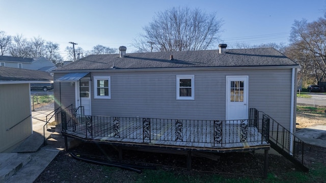 rear view of property featuring a wooden deck