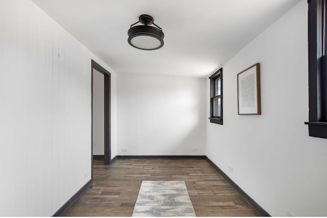 unfurnished room with dark wood-type flooring