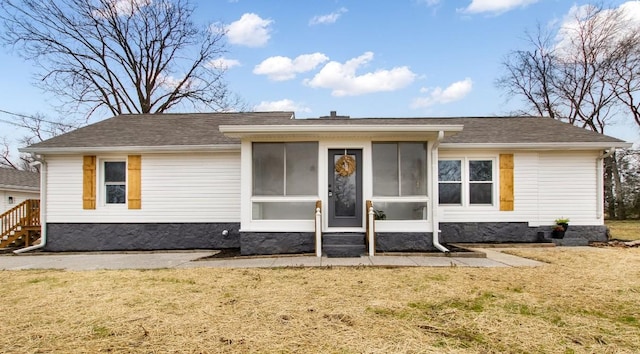 view of front of house featuring a front yard and a sunroom