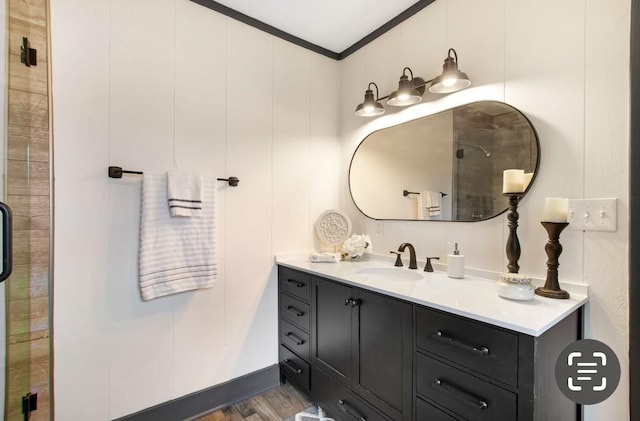 bathroom with hardwood / wood-style floors, vanity, and crown molding