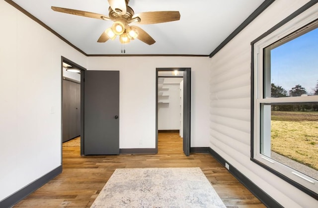 bedroom with ceiling fan, light hardwood / wood-style floors, and crown molding