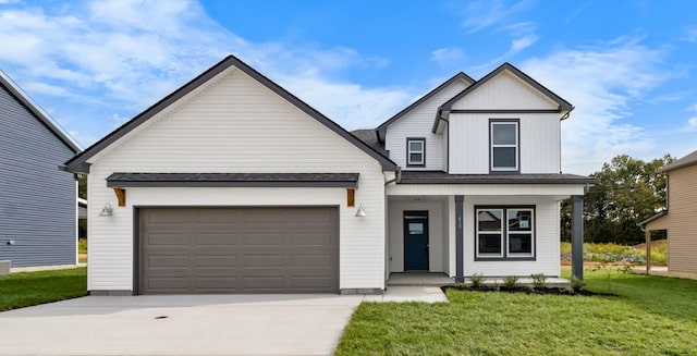 modern farmhouse featuring covered porch, a front yard, and a garage